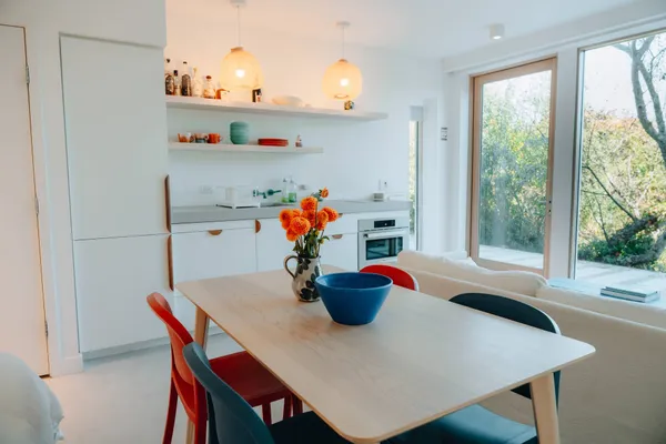a bed room with a bed table chair and a window