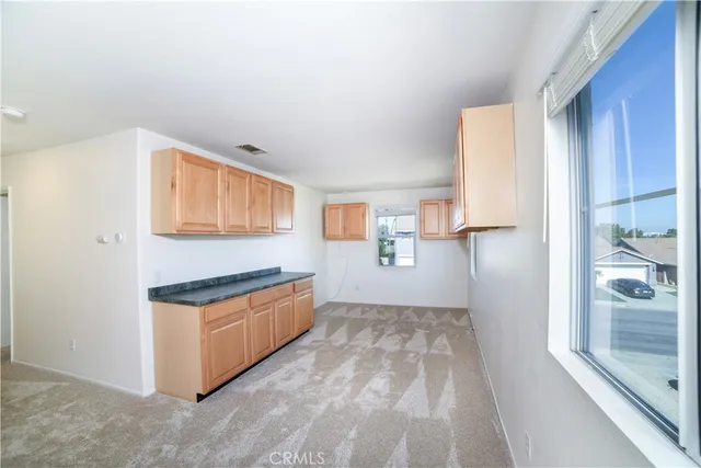 a kitchen with stainless steel appliances granite countertop a refrigerator and a stove