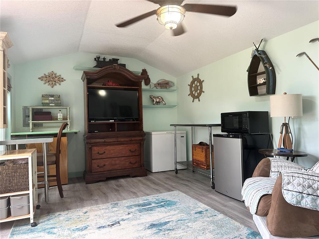 357 Magnolia Place DeBary, FL 32713 - Photo 47 of 50 a living room with furniture and a flat screen tv