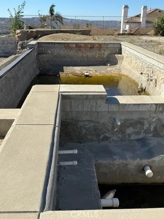 a view of a swimming pool with a lounge chair