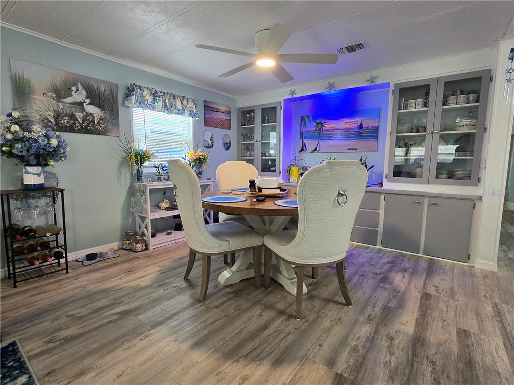5619 Bayshore Road, Unit 435 Palmetto, FL 34221 - Photo 13 of 56 a view of a dining room with furniture and wooden floor
