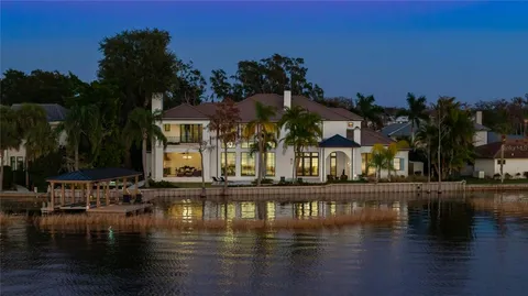 a view of pool with outdoor seating and lake view