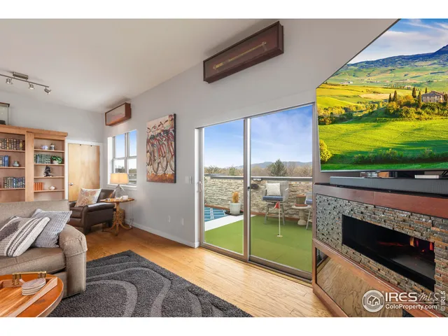 a living room with fireplace furniture and a flat screen tv