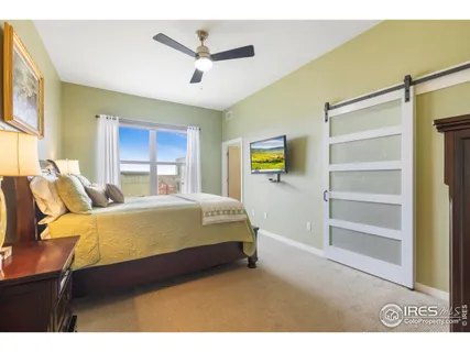 a bedroom with a bed a dresser and a window