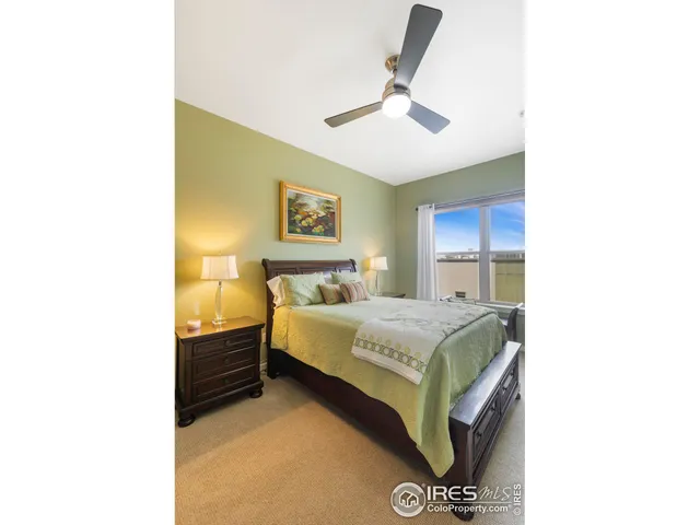 a bedroom with a bed dresser and a lamp