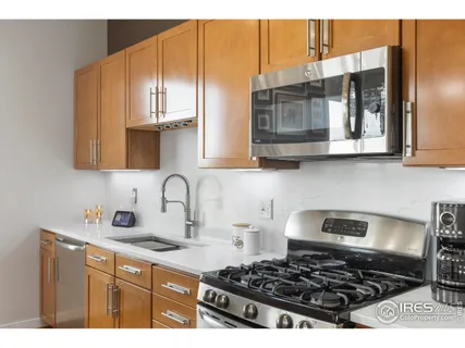 a kitchen with stainless steel appliances a stove a sink and a microwave