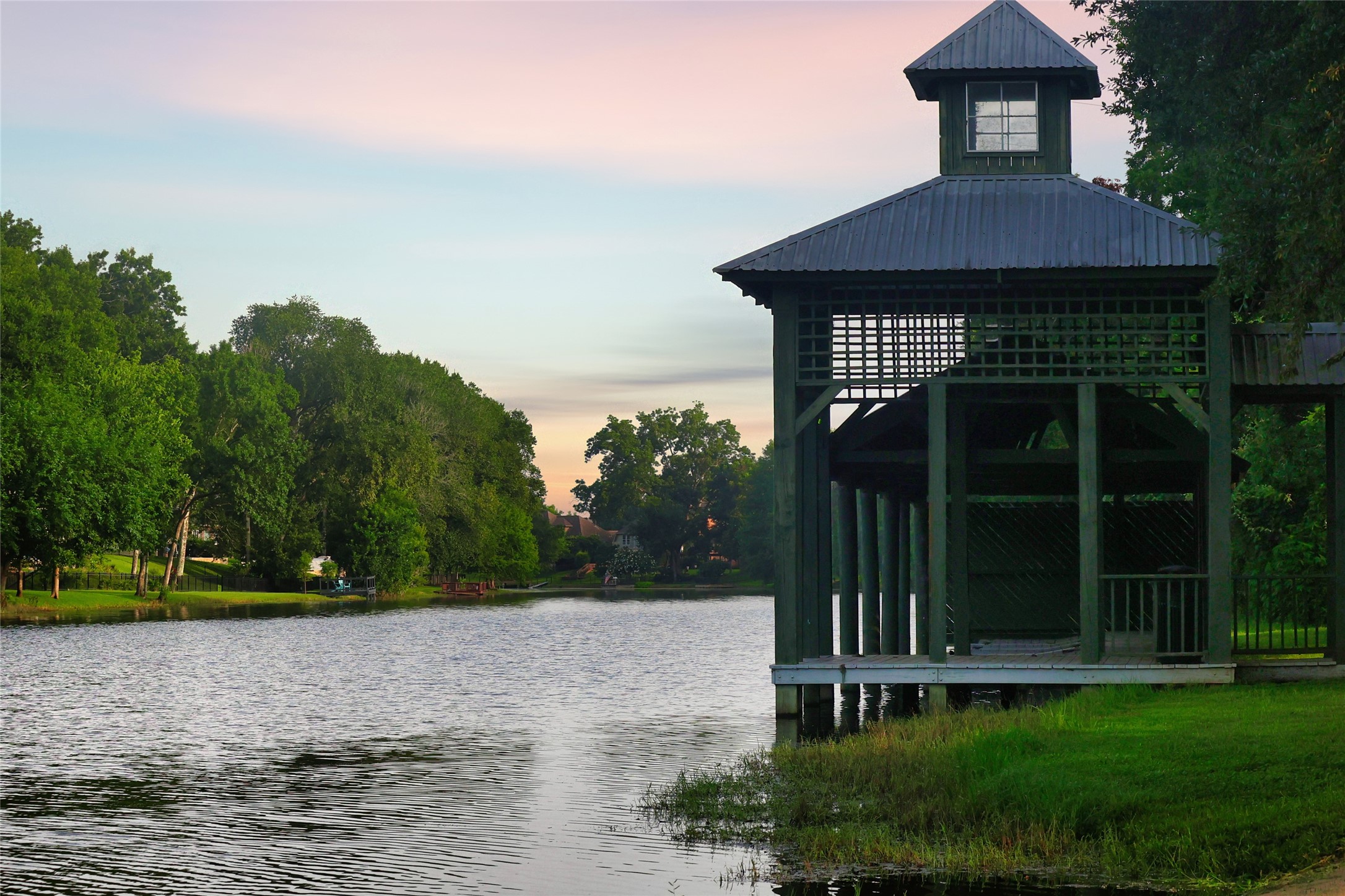 0 Riverlake Road Fulshear, TX 77441 - Photo 23 of 47 Fulbrook's covered lakeside dock offers residents a tranquil setting to enjoy fishing, wildlife watching, or simply taking in the beauty of the community's scenic waterways and natural surroundings.