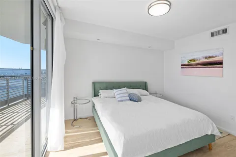 a bedroom with a bed and a mirror
