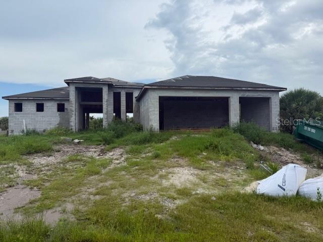 a front view of house with yard and trees around
