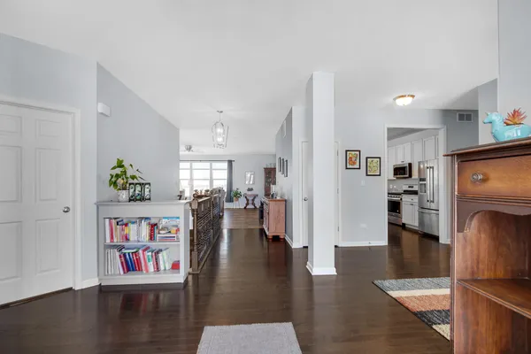 a living room with furniture and a book shelf