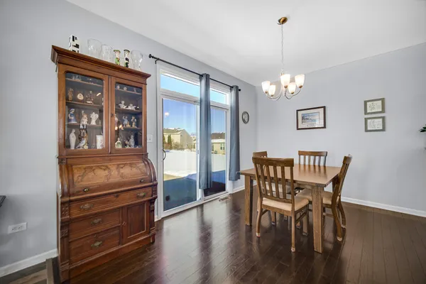 a view of a dining room with furniture wooden floor and chandelier