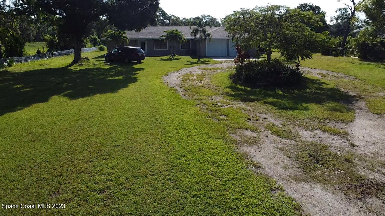 2745 Corey Road Malabar, FL 32950 - Photo 30 of 39 a view of a garden with a large tree