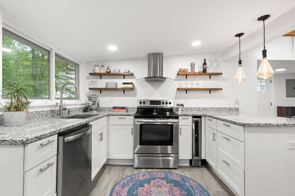 47 South Shore Road Holbrook, MA 02343 - Photo 11 of 30 a kitchen with stainless steel appliances granite countertop a sink stove and cabinets
