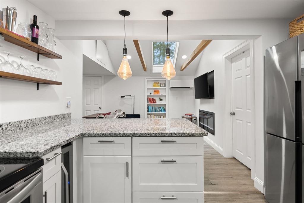 47 South Shore Road Holbrook, MA 02343 - Photo 14 of 30 a kitchen with stainless steel appliances granite countertop a sink a microwave a refrigerator and a wooden floor