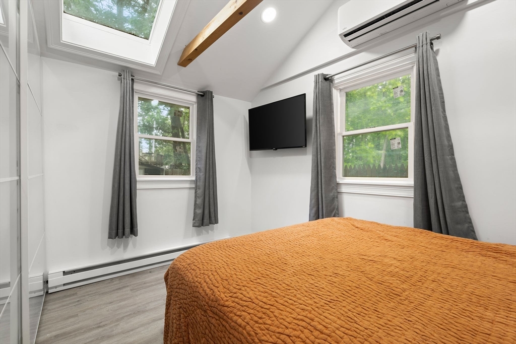 47 South Shore Road Holbrook, MA 02343 - Photo 16 of 30 a bedroom with a bed and a flat screen tv