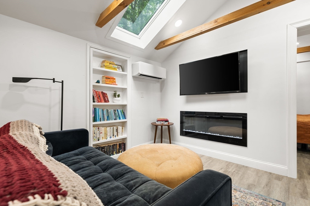 47 South Shore Road Holbrook, MA 02343 - Photo 6 of 30 a bedroom with a bed a flat screen tv and a fireplace