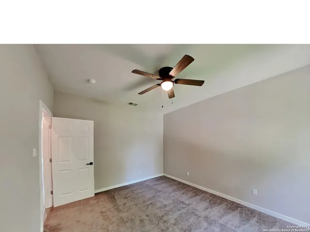 a view of room with a ceiling fan
