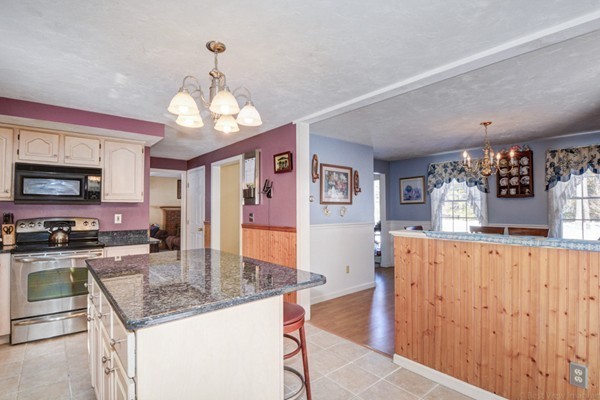 88 Mason Road Townsend, MA 01474 - Photo 14 of 30 a kitchen with stainless steel appliances granite countertop a sink dishwasher and a refrigerator with wooden floor