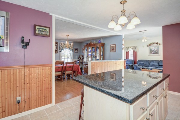88 Mason Road Townsend, MA 01474 - Photo 17 of 30 a view of kitchen island a refrigerator wooden floor and furniture