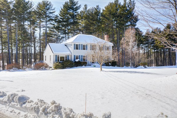 88 Mason Road Townsend, MA 01474 - Photo 2 of 30 a front view of a house with a yard covered with snow