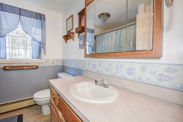 88 Mason Road Townsend, MA 01474 - Photo 27 of 30 a bathroom with a sink a toilet and a mirror