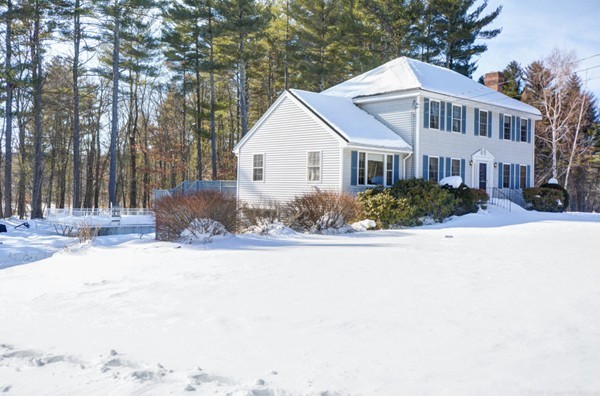 88 Mason Road Townsend, MA 01474 - Photo 3 of 30 a front view of a house with a yard covered with snow