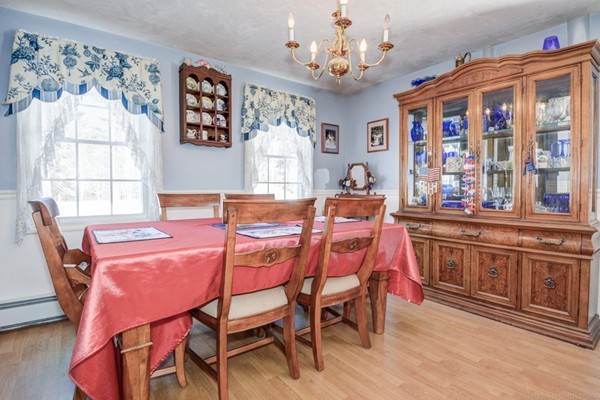 88 Mason Road Townsend, MA 01474 - Photo 8 of 30 a dining room with wooden floor a chandelier a wooden table and chairs