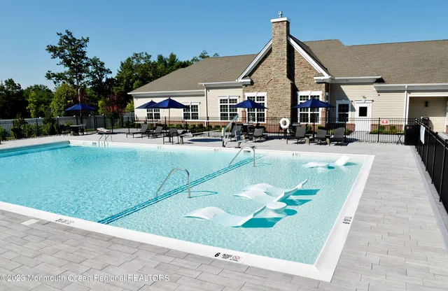 a swimming pool view with a outdoor seating