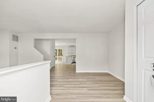 a view of a living room with wooden floor