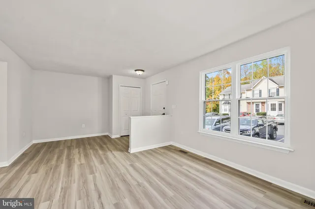 wooden floor in an empty room with a window