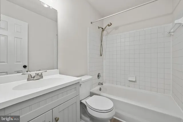 an empty room with a window and a ceiling fan