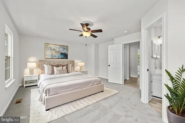 a spacious bedroom with a bed and a chandelier