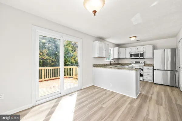 a kitchen with white cabinets and white appliances