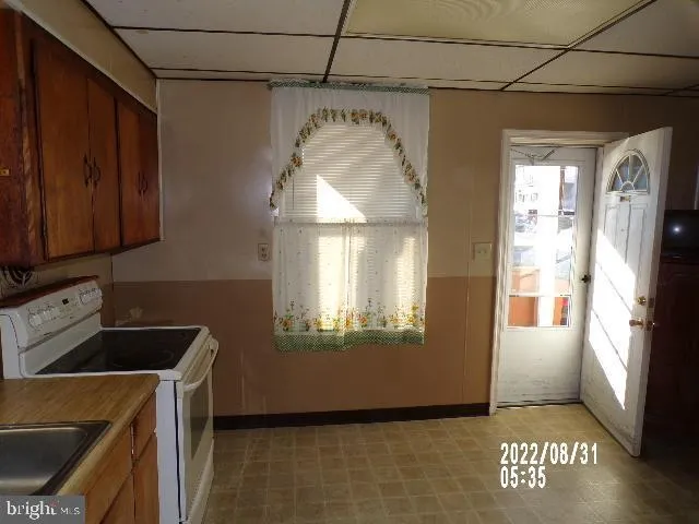 a kitchen with a refrigerator and a sink