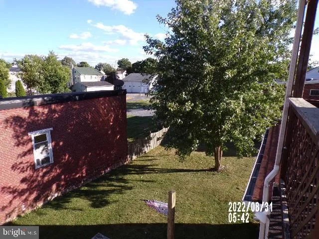 a view of a backyard with sitting area