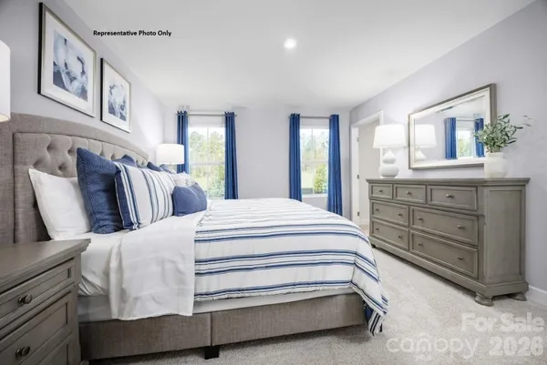 a bedroom with a bed and painting on the wall