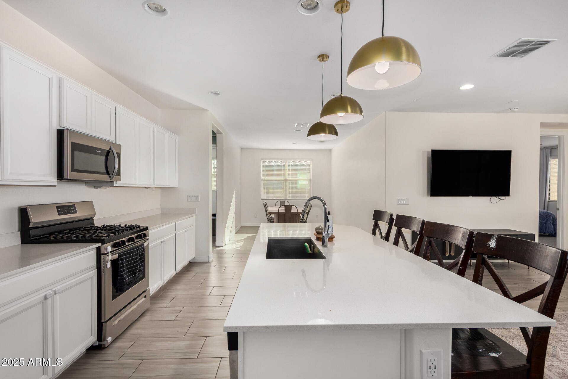 2652 South Prospector Point Road Apache Junction, AZ 85119 - Photo 14 of 37 a kitchen with a table chairs microwave and cabinets