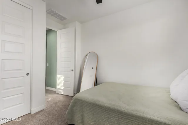 a bedroom with a bed and a dresser