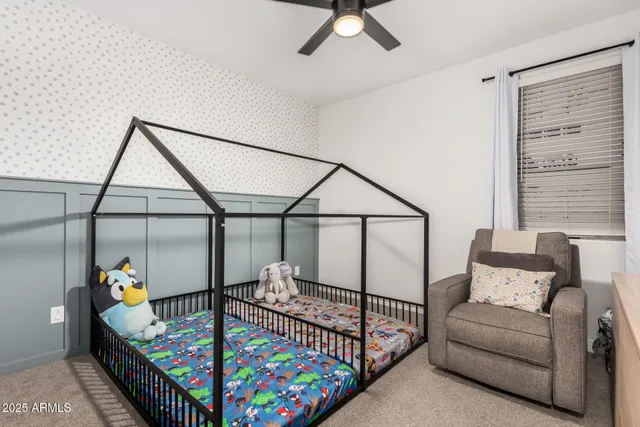 a bedroom with furniture and a baby crib