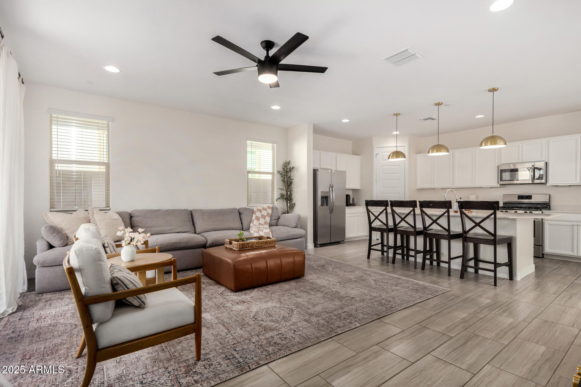 2652 South Prospector Point Road Apache Junction, AZ 85119 - Photo 9 of 37 a living room with furniture kitchen view and a chandelier