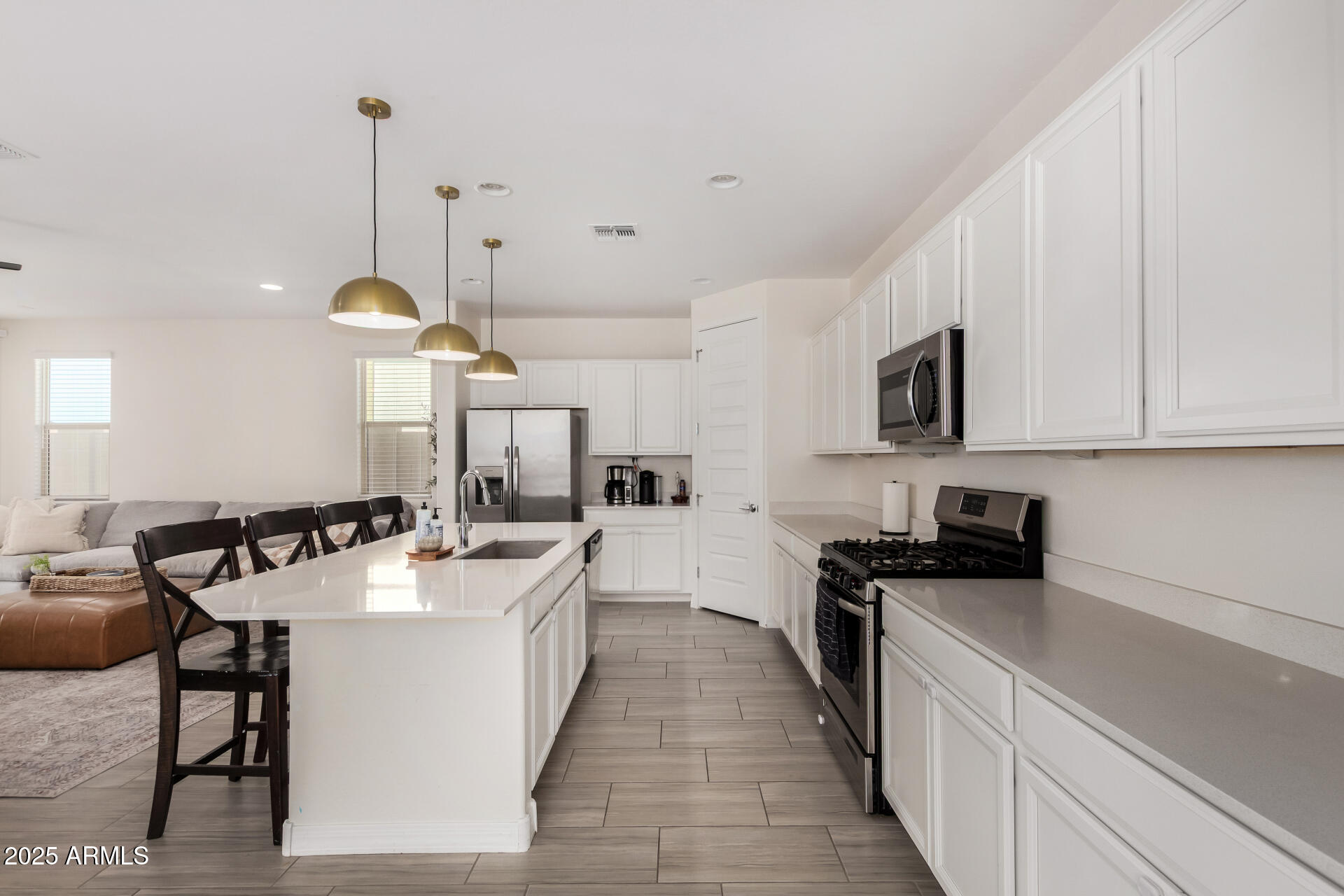 2652 South Prospector Point Road Apache Junction, AZ 85119 - Photo 10 of 37 a kitchen with a sink a counter top space a stove and cabinets