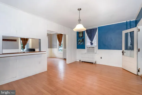 a view of a living room with hardwood floor and a ceiling fan