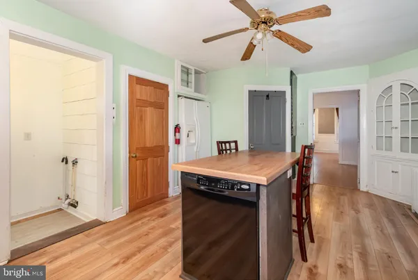 a view of a kitchen cabinets a sink and wooden floor