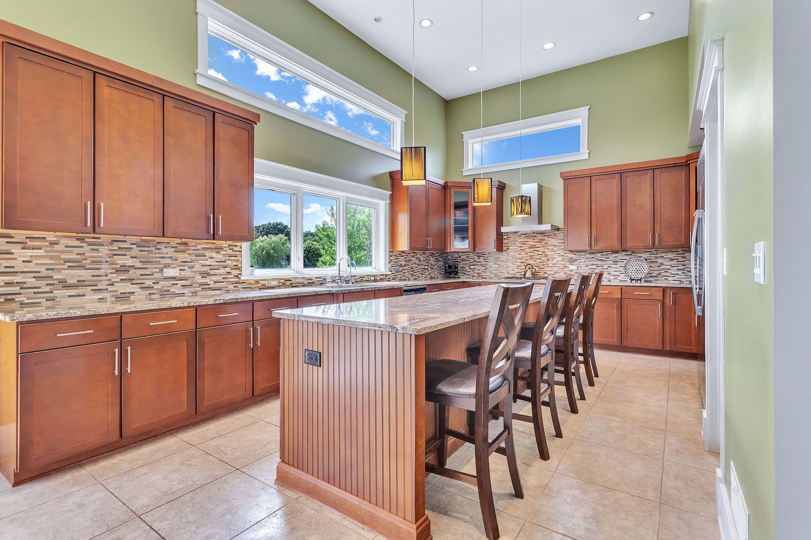 40 Stonecrest Drive Elgin, IL 60124 - Photo 13 of 63 a kitchen with stainless steel appliances granite countertop wooden cabinets a dining table and chairs