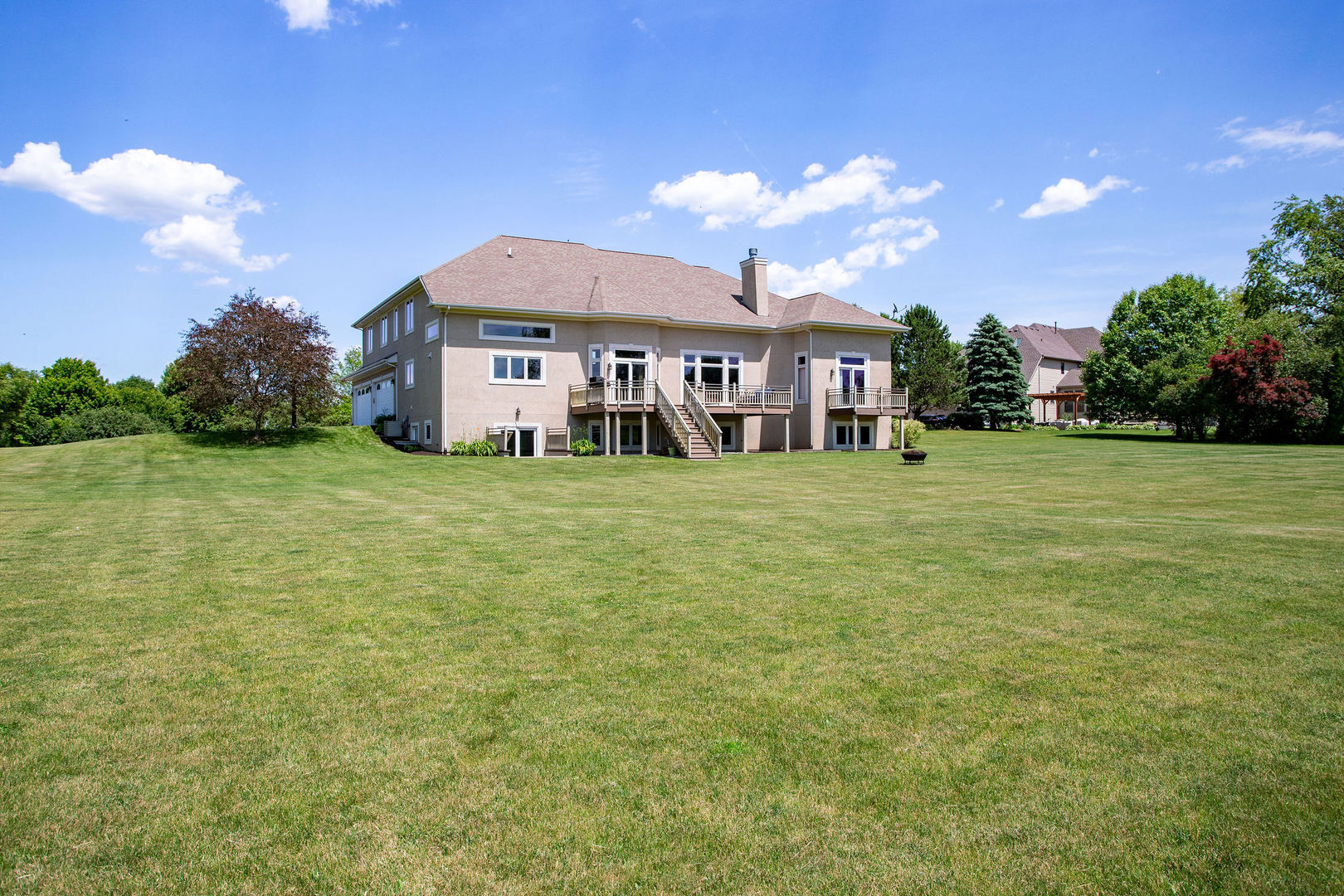 40 Stonecrest Drive Elgin, IL 60124 - Photo 46 of 63 a big white house with a big yard and large trees