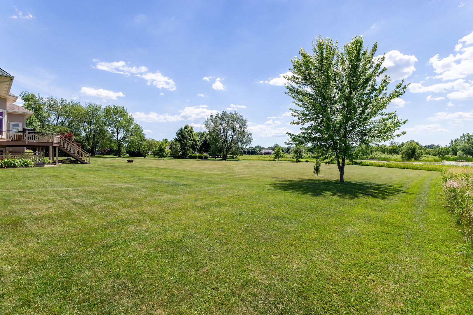 40 Stonecrest Drive Elgin, IL 60124 - Photo 55 of 63 a backyard of a house with lots of green space and lake view