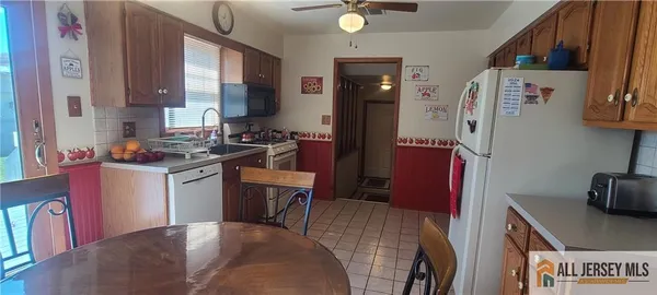 a kitchen with a refrigerator and a stove top oven