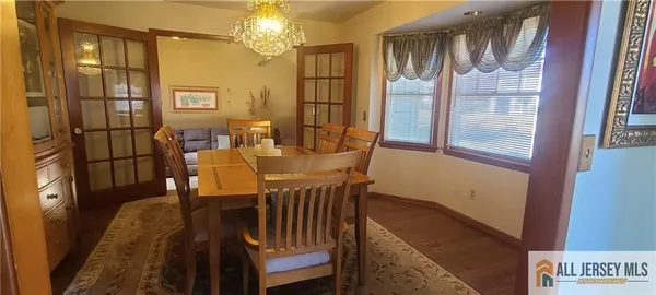 a view of a dining room with furniture and a chandelier