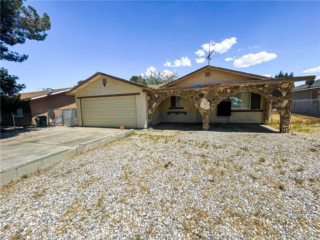 18225 Casaba Road Adelanto, CA 92301 - Photo 1 of 1 a front view of a house with a yard
