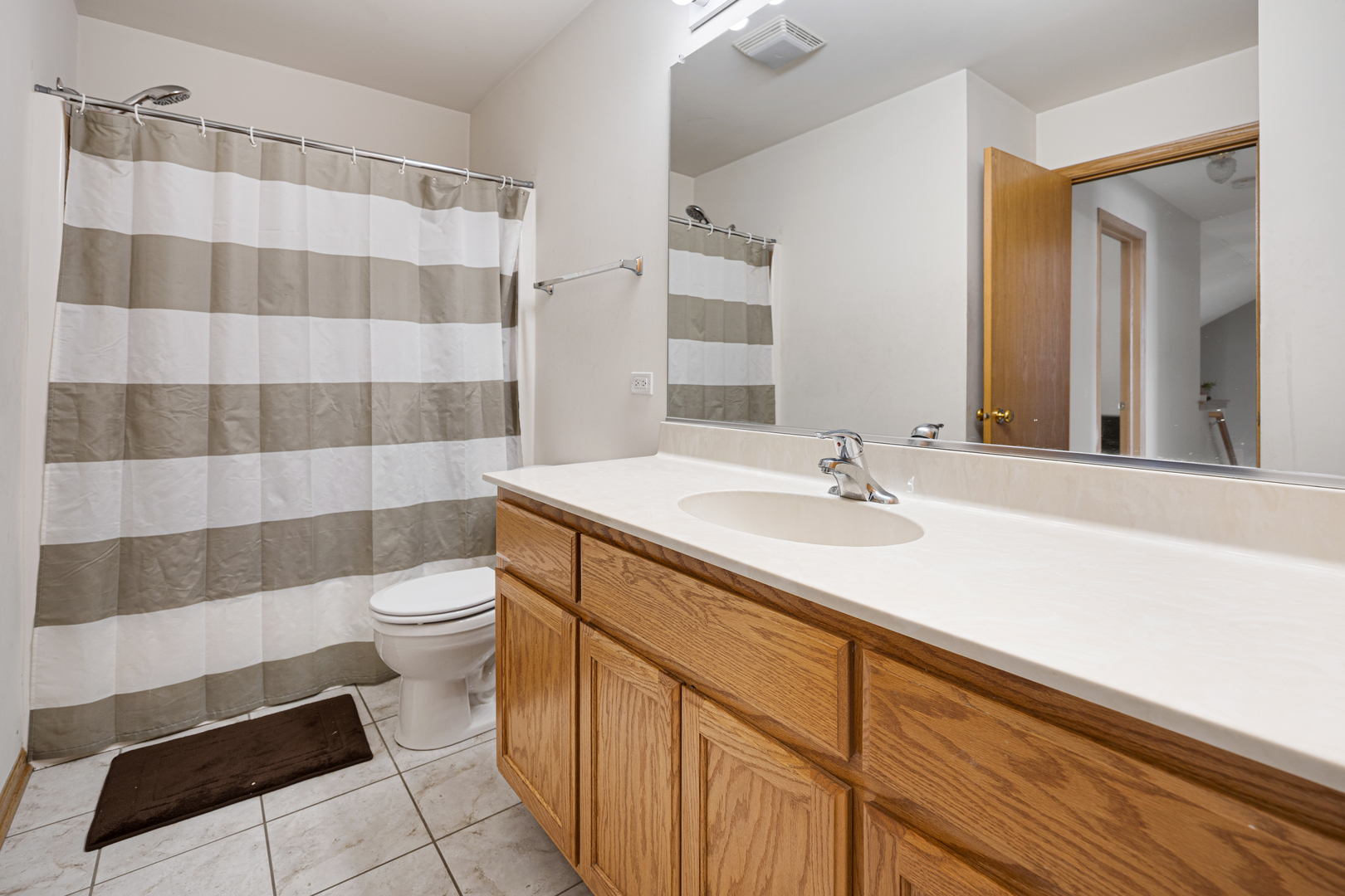 1014 Edinburgh Court Joliet, IL 60431 - Photo 17 of 25 a bathroom with a sink a toilet a shower and a mirror